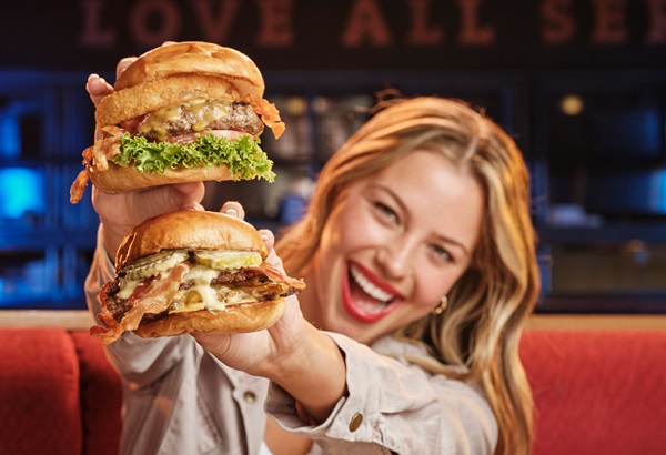 Girl holding two burgers